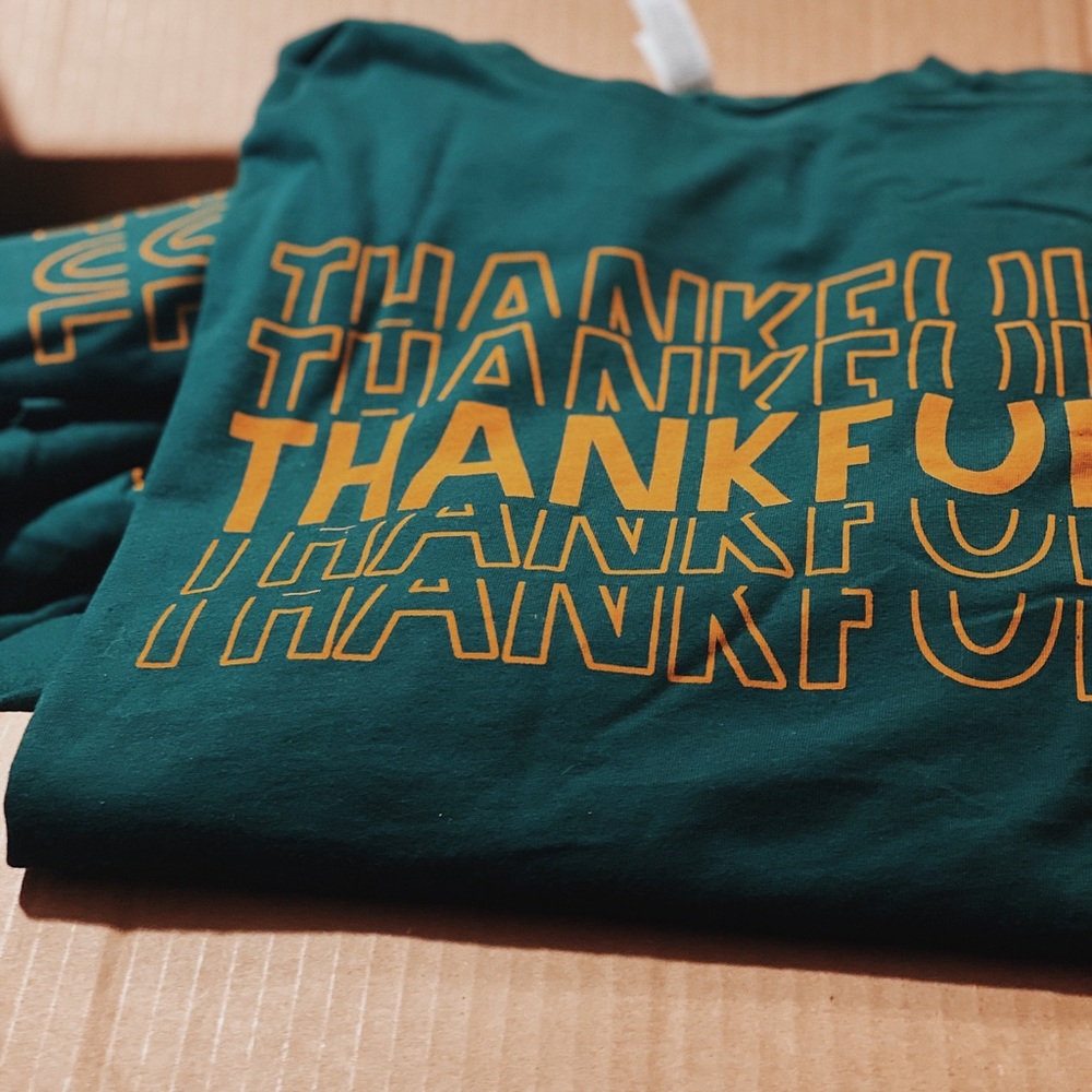 Green Thankful graphic tshirt with gold lettering
